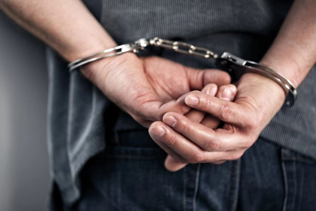 Hands cuffed behind back closeup