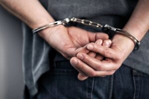 Hands cuffed behind back closeup