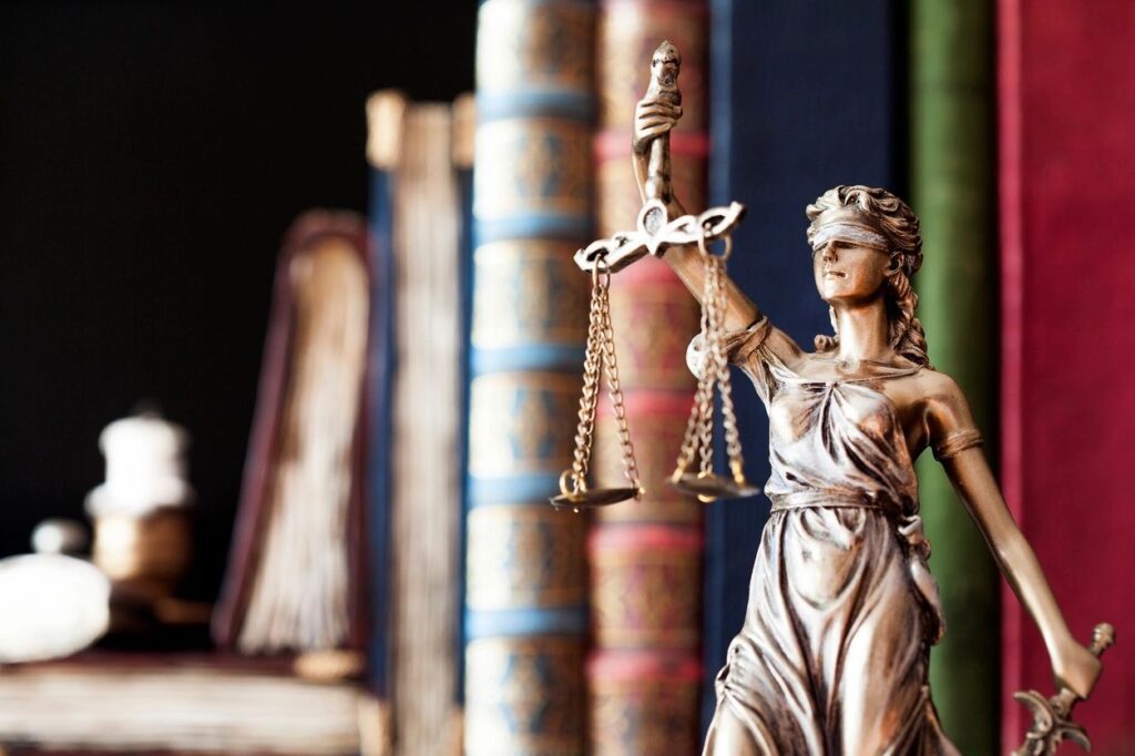Bronze Lady Justice statue with books