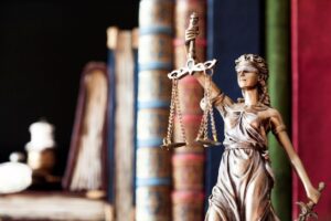 Bronze Lady Justice statue with books