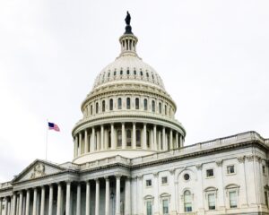 US Capitol dome with small flag