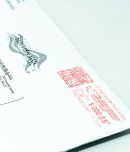 Mail ballot envelope with red postage mark