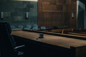 Courtroom bench with gavel in foreground