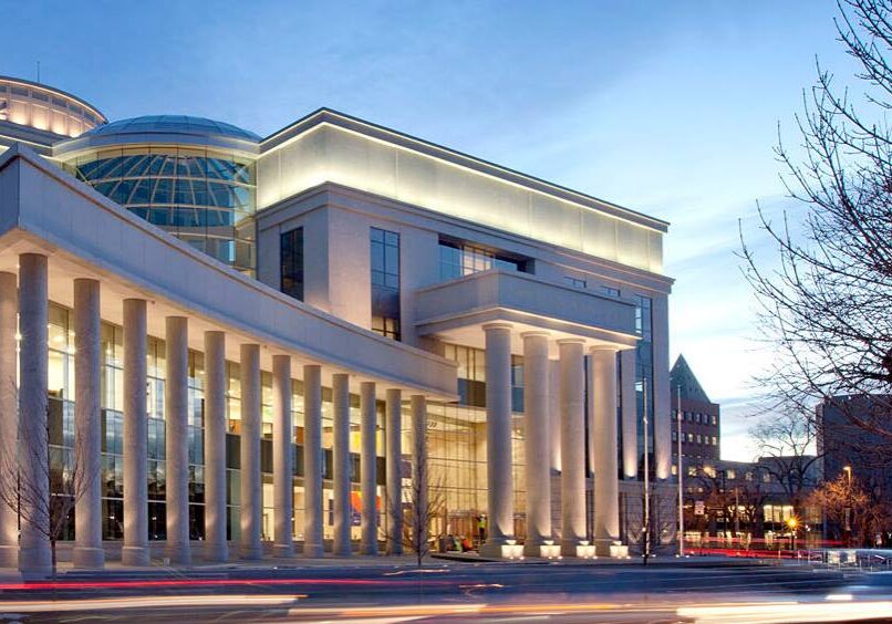 Neoclassical courthouse exterior lit at dusk