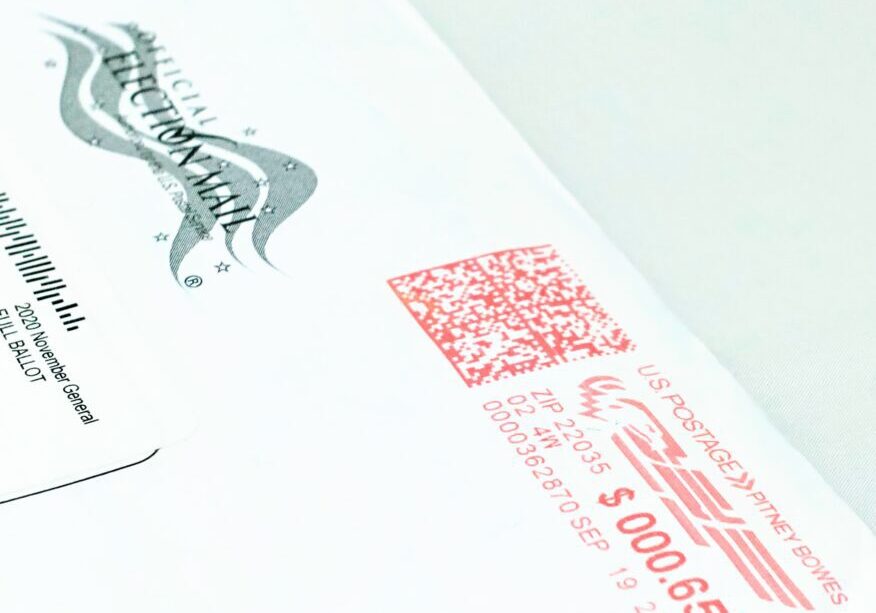 Mail ballot envelope with red postage mark