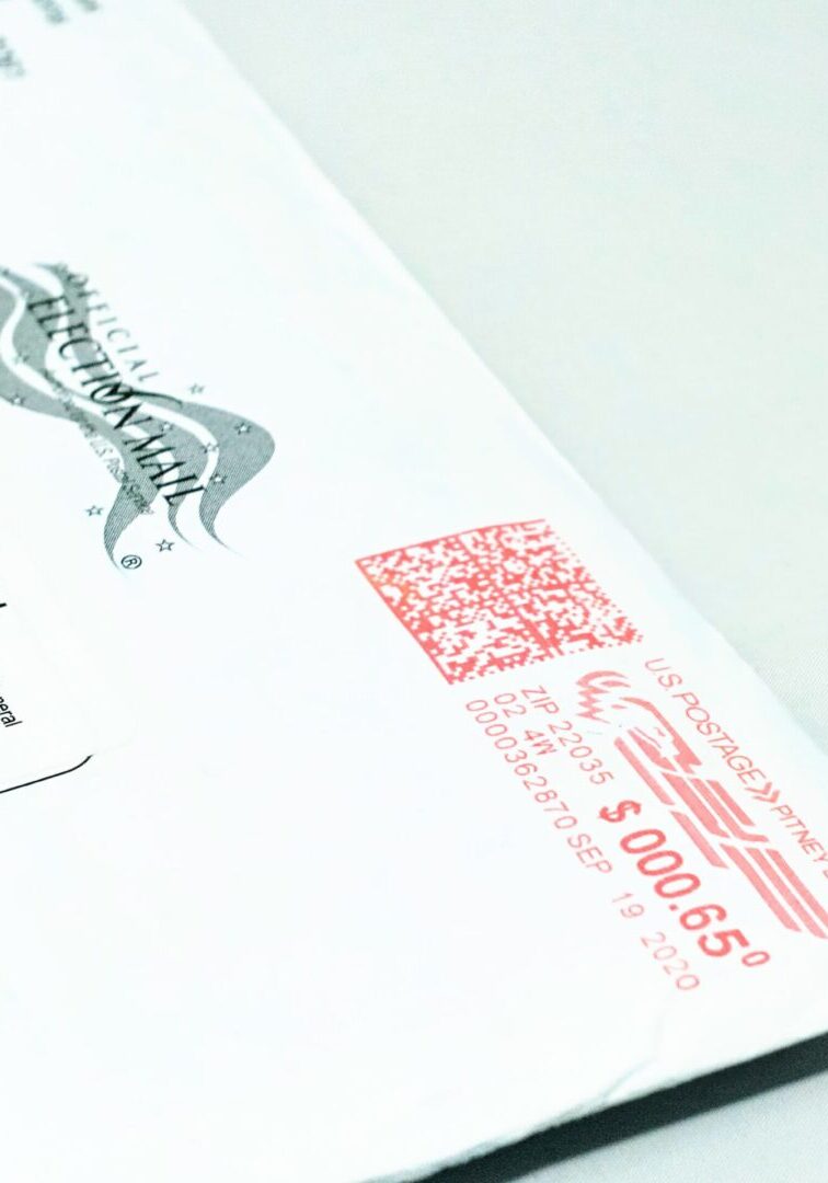 Mail ballot envelope with red postage mark