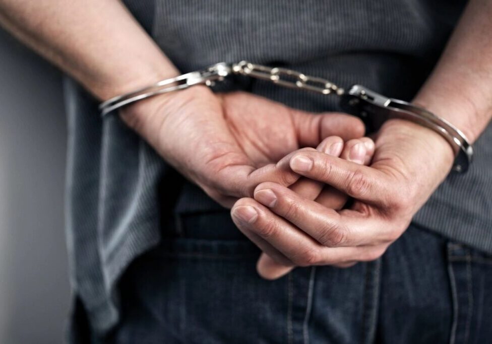 Hands cuffed behind back closeup