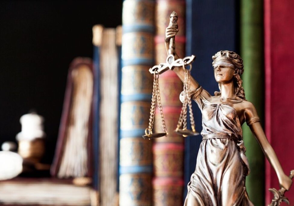 Bronze Lady Justice statue with books