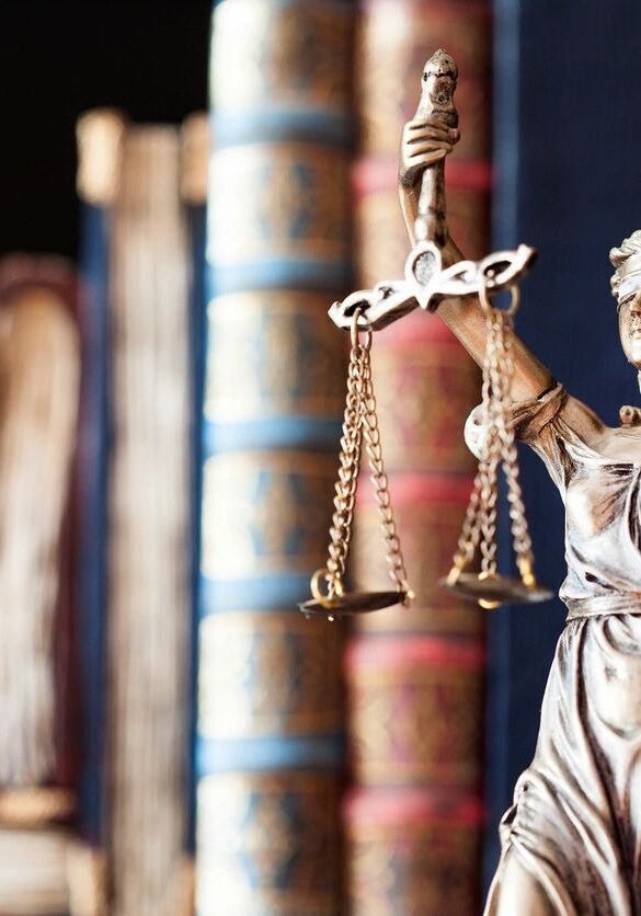 Bronze Lady Justice statue with books