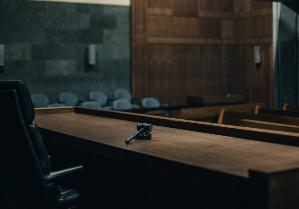 Courtroom bench with gavel in foreground