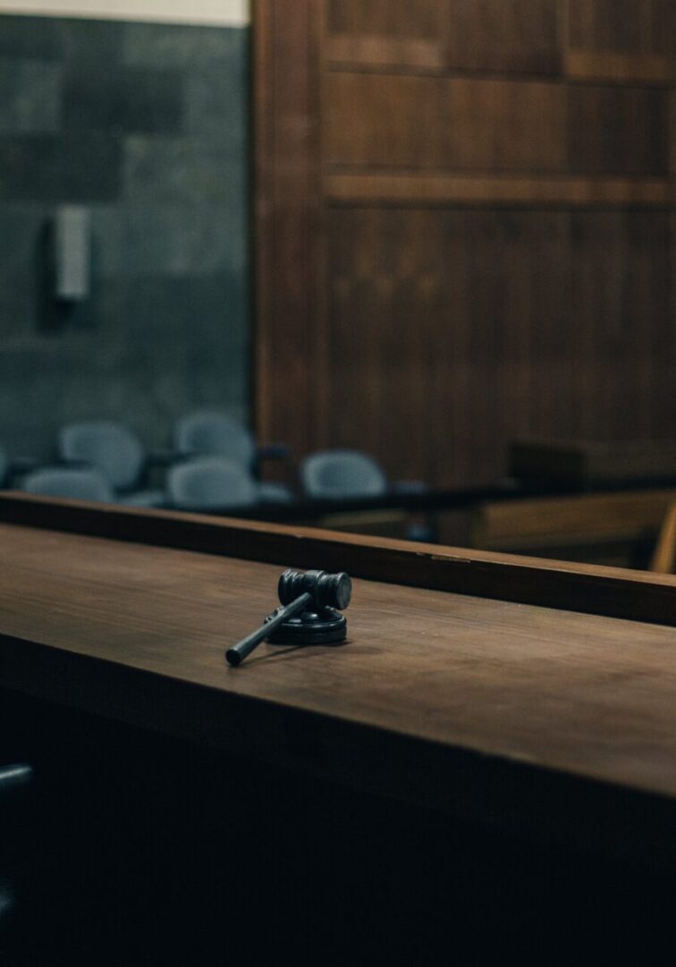 Courtroom bench with gavel in foreground